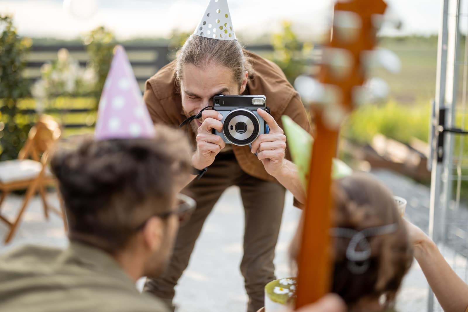 Guest taking an instant photo at a party